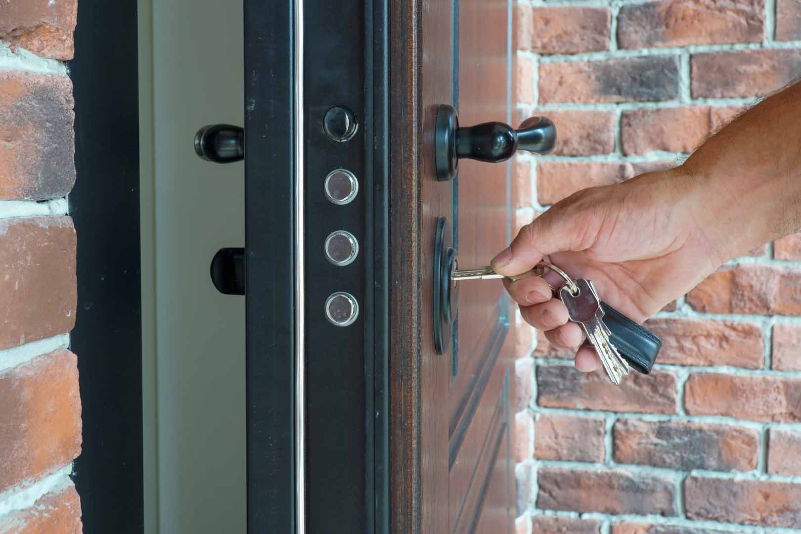 The,Man,Inserts,The,Key,Into,The,Lock,To,Close