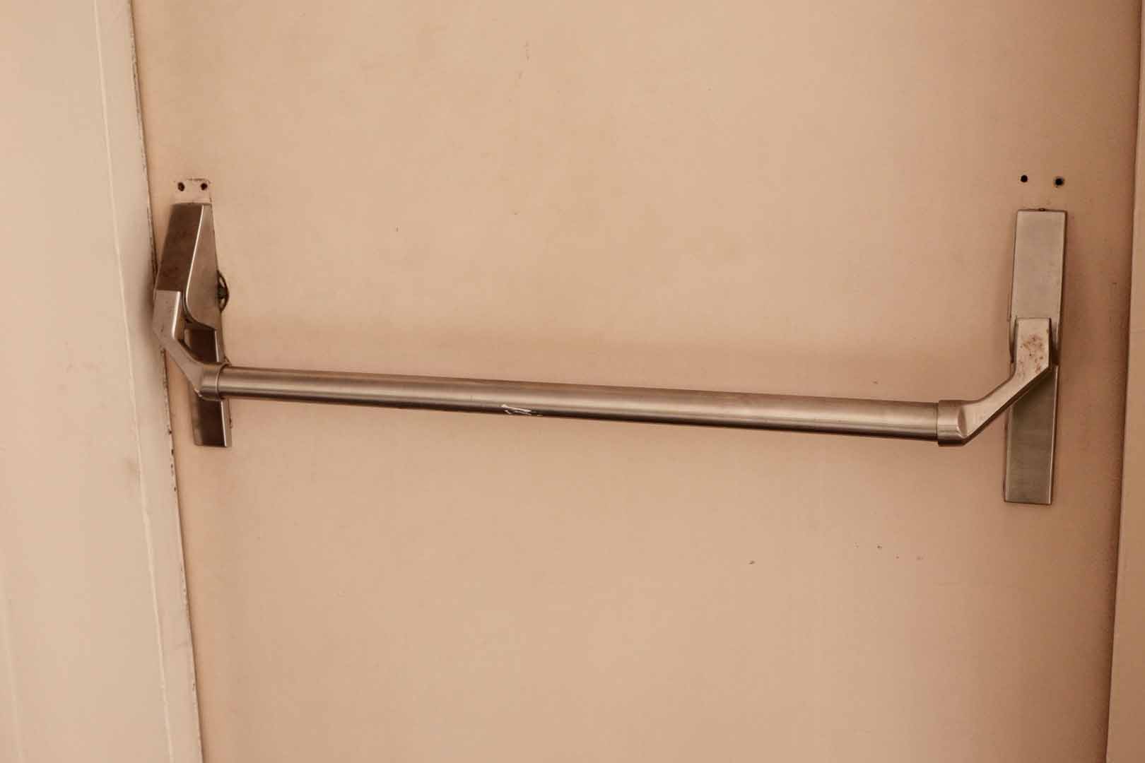 Metal,Emergency,Exit,Push,Bar,On,A,Beige,Door,,Ideal